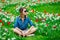 Young redhead girl sitting at tulips meadow