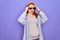 Young redhead pregnant woman expecting baby wearing funny thug life sunglasses suffering from headache desperate and stressed