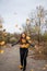 Young redhead woman in autumn park.