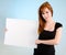 Young Redhead Woman Holding a Blank White Sign