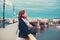 Young redhead woman in leather jacket smile on Margaret bridge,