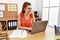 Young redhead woman smiling confident working at office