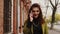 Young redhead woman walking in a street talking on the phone