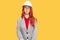 Young redhead woman wearing architect hardhat making fish face with lips, crazy and comical gesture