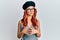 Young redhead woman wearing fashion french look with beret hands together and fingers crossed smiling relaxed and cheerful