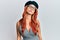 Young redhead woman wearing fashion french look with beret looking at the camera blowing a kiss on air being lovely and sexy