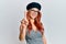 Young redhead woman wearing fashion french look with beret pointing finger up with successful idea