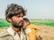 A young refugee child is sleeping on the shoulder of his father and both looks so tired hungry and terrified