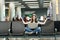 Young relaxed traveler tourist woman with laptop sitting with crossed legs, meditate, spread hands, waiting in lobby