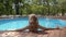 Young relaxed woman is enjoying good summer weather lying in swimming pool of hotel