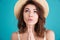 Young religious girl in straw hat praying for a vacation