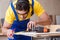 The young repairman carpenter working cutting wood on circular saw