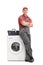 Young repairman leaning on a washing machine
