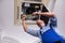 The young repairman repairing ceiling air conditioning unit