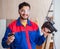 Young repairman working with a power saw sawing