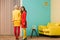 young retro styled women standing in colorful room doll