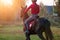 Young rider girl on bay horse in the autumn park