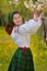 Young Romanian girl smiling in the spring time with traditional costume