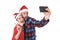 Young romantic couple in love taking selfie mobile phone photo at Christmas