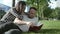 Young romantic couple lying in park and reading book.