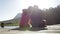 Young Romantic Couple Sitting On End Of Wooden Jetty By Lake