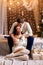 Young romantic couple waiting for new year and Christmas holiday, beautiful bokeh