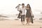 Young romantic couple walking along beach