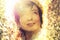 Young romantic woman with wreath of dandelions on the head