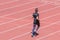 Young runner jogging on track at stadium