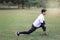 Young runner man stretching body before exercise run outdoor in park  hansom sport male jogger athlete training and doing workout