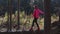 Young, rural girl walking on a log, against the autumn forest