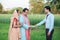 Young rural indian couple farmer receive money from banker at