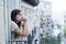 Young sad beautiful woman suffering depression looking worried and wasted on home balcony