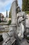 The young sad grieving woman statue leaning on the column