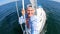 Young sailor alone recording selfie from Sailboat's bow in open sea. Freedom, adrenaline concept