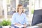 Young sales assistant writing something at office desk