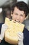 Young Salesman Eating Cheese In Store