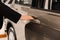 Young salesman in suit opening car door, closeup