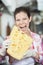 Young Saleswoman Biting Cheese In Store