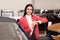 Young saleswoman near car in dealership