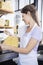 Young Saleswoman Packing Cheese At Store