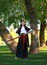 Young samurai lady woman in traditional kimono with katana sword in forest park, culture of asia female warriors