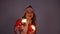 Young santa claus woman in red christmas or new year coat and hat holding sparkler