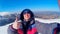 Young satisfied happy guy takes a selfie against the backdrop of a stunning winter landscape. Carpathians.