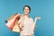 Young satisfied shopaholic with several paperbags