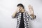 Young scared Asian man isolated on white background, looks depressed, face covered by fingers frightened and nervous