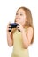 Young scared cute girl with grey blue eyes and long light brown hair plays computer game with joystick