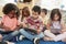 Young school kids in class using tablet computers, close up