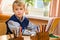 Young schoolboy sitting Behind a school desk