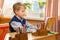 Young schoolboy sitting Behind a school desk